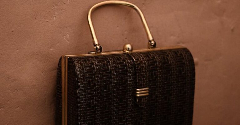 Vintage Trends - Vintage bag with golden handle placed on reflecting surface as accessory for garment