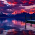 Dark Tourism - Dock Under Cloudy Sky in Front of Mountain