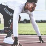 Athlete - Man Wearing White Sweater and Black Shorts About to Run