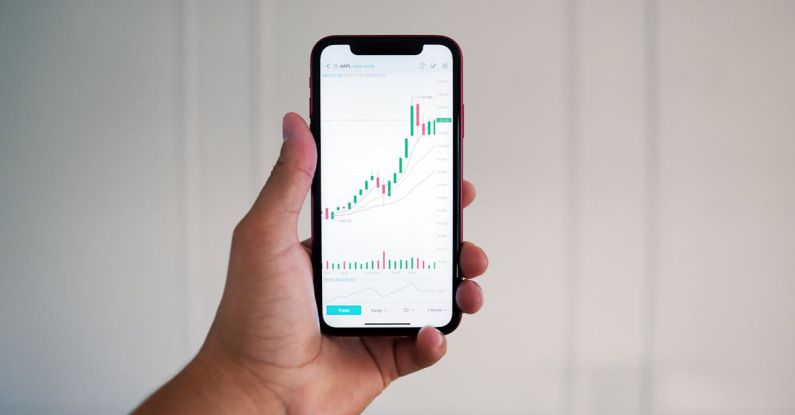 Day Trading - Person Holding a Phone with Data on the Screen